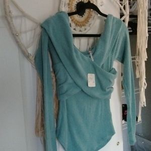 It is a blue sweater from free people